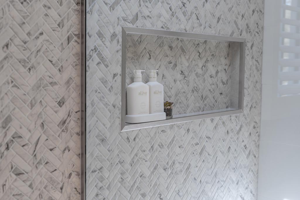 marble herringbone feature tile bathroom design in mitchelton by she's got style interior designer