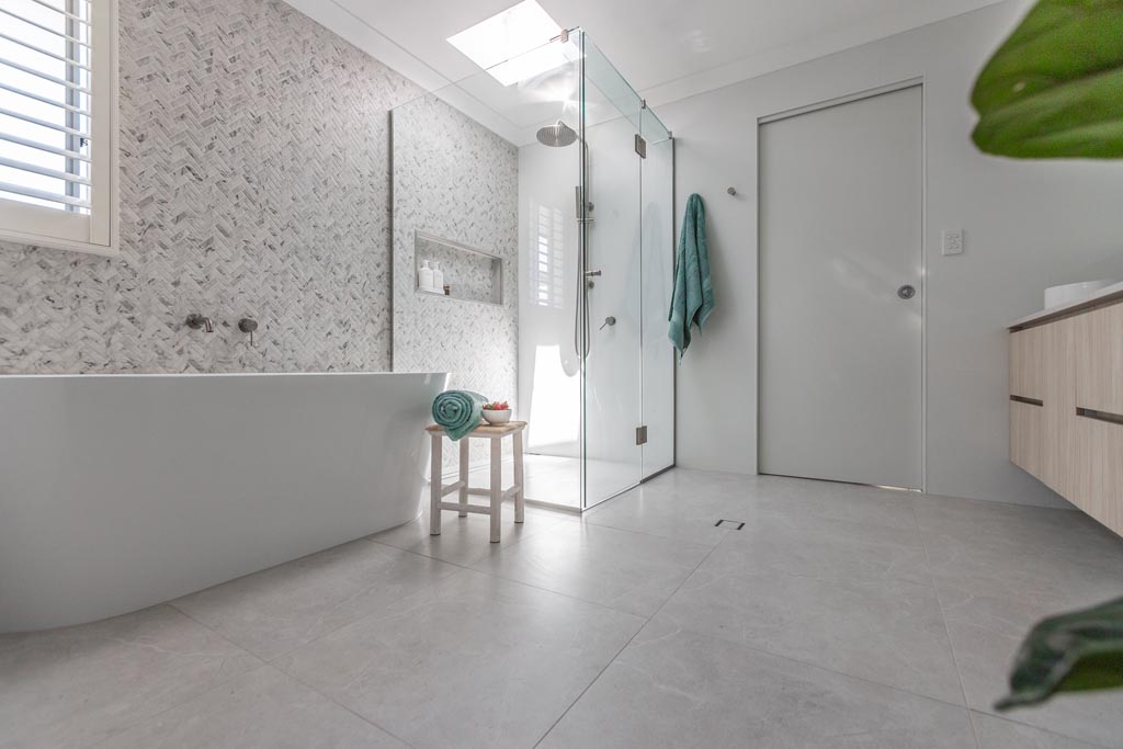 master bathroom design in mitchelton showcasing herringbone marble tile by she's got style